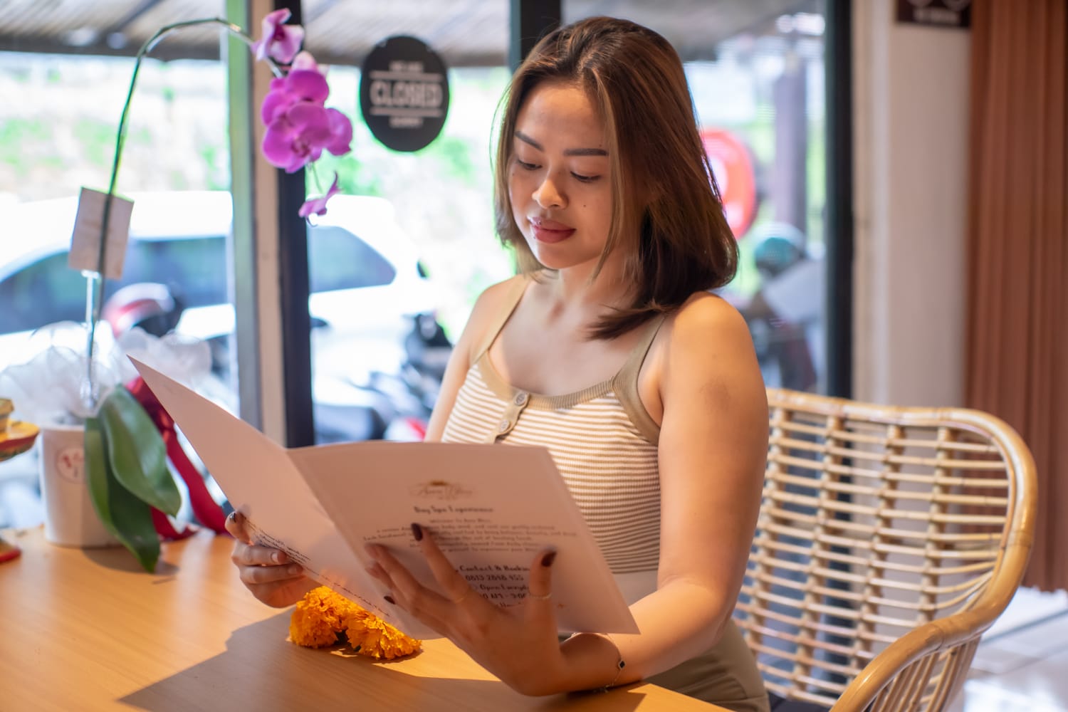 A guest reading the Aura Bliss spa menu