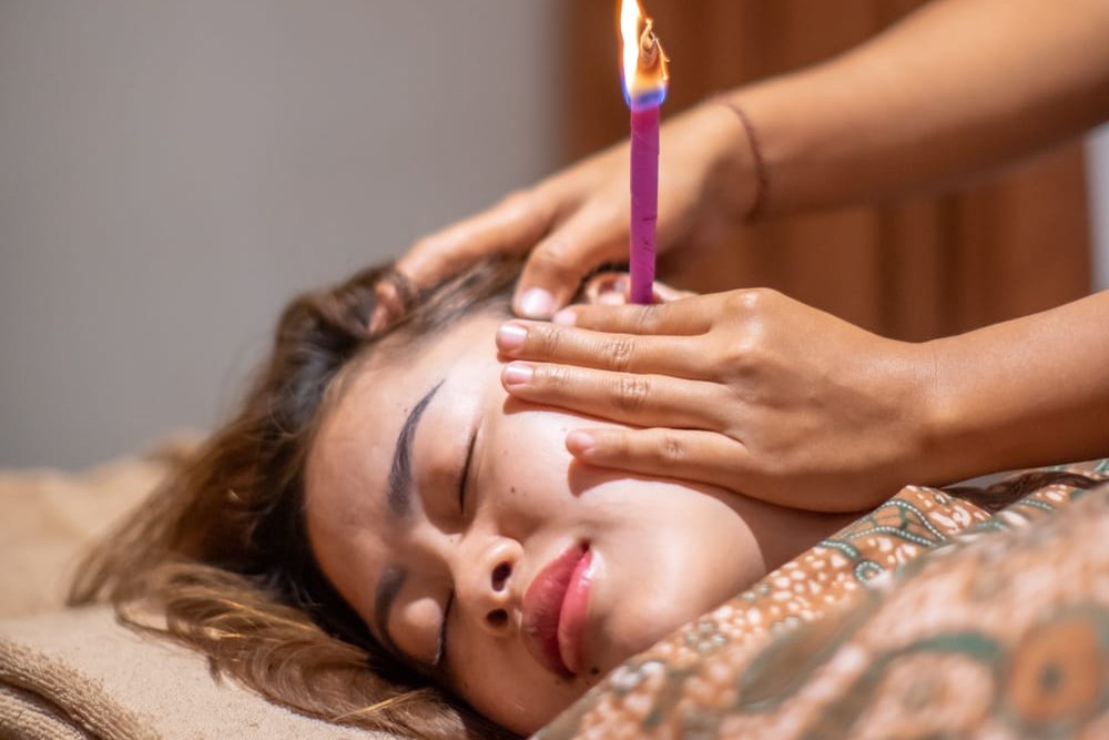 Ear candling treatment in progress at Aura Bliss Spa