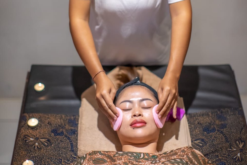 Facial massage treatment in progress at Aura Bliss Spa