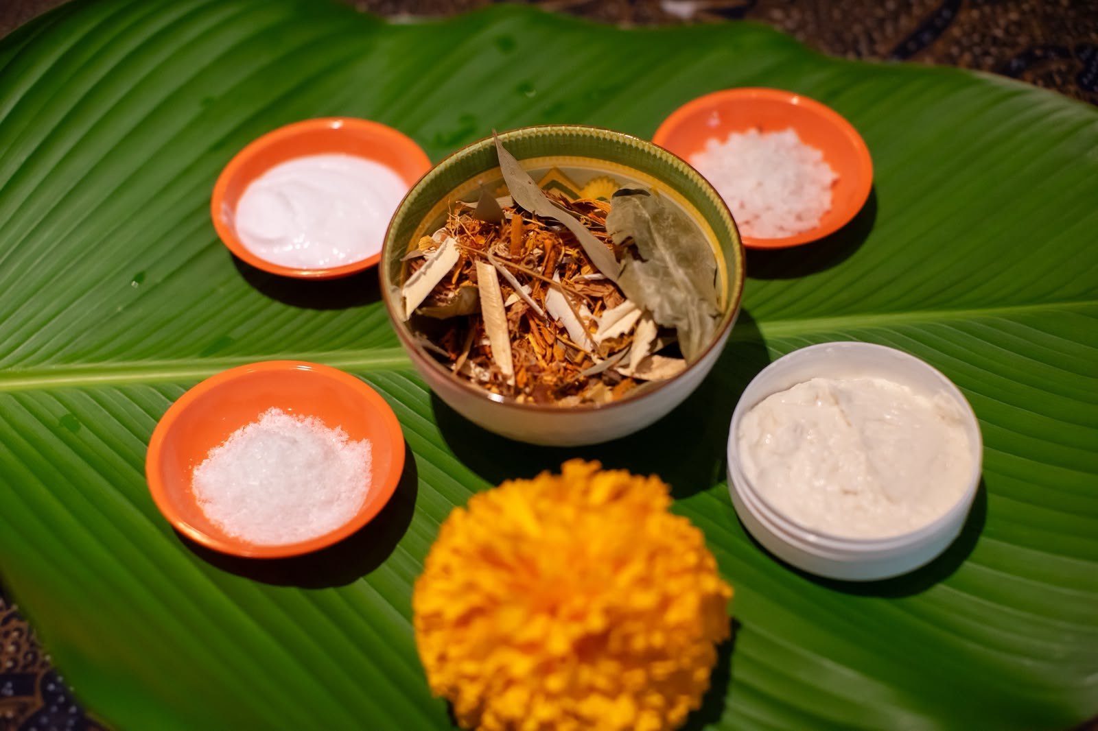 Herbal ingredients prepared on a banana leaf for a spa treatment